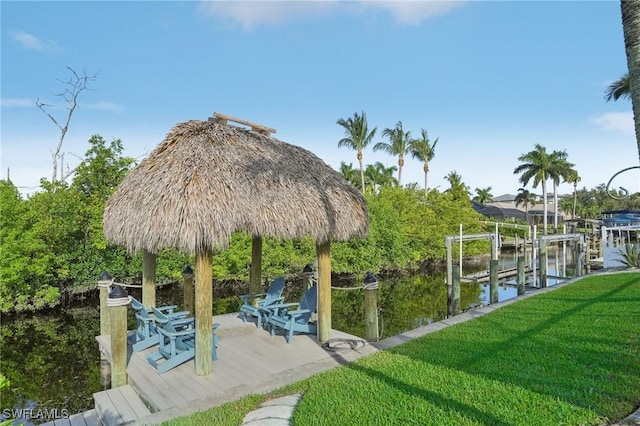 dock area with a yard and a water view