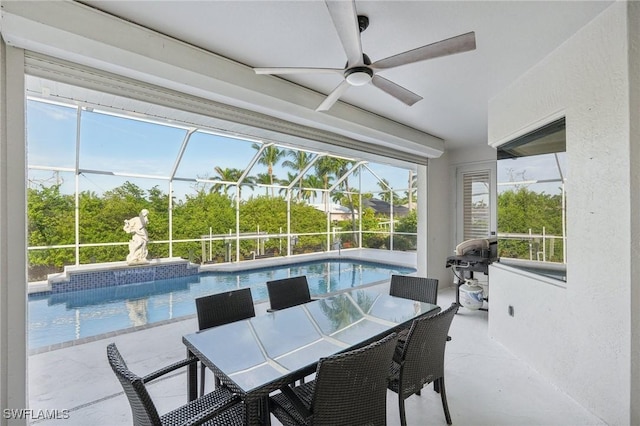 sunroom featuring ceiling fan and plenty of natural light