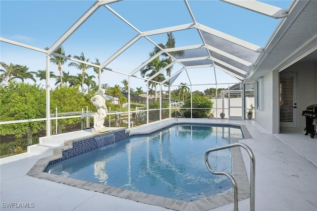 view of swimming pool featuring pool water feature, a lanai, a patio area, and a grill