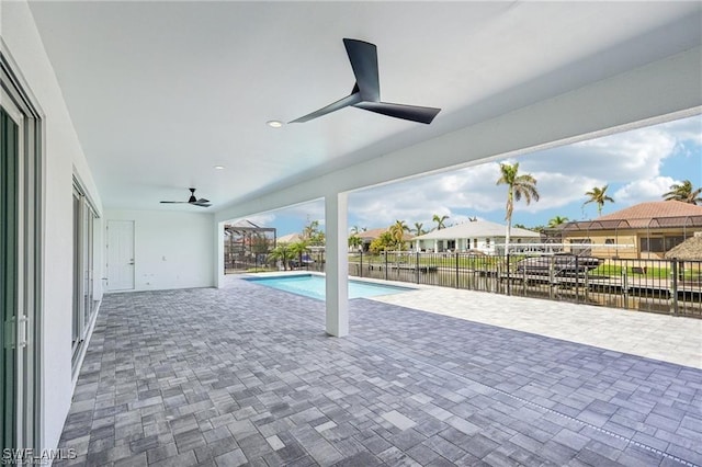 view of swimming pool with ceiling fan, a patio, a water view, fence, and a fenced in pool