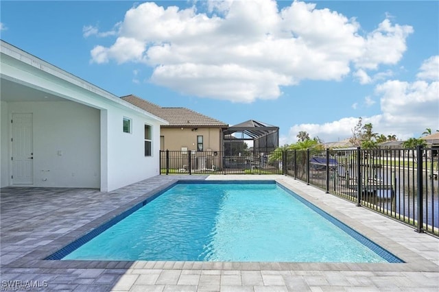 view of swimming pool featuring a fenced in pool, glass enclosure, a water view, fence, and a patio area