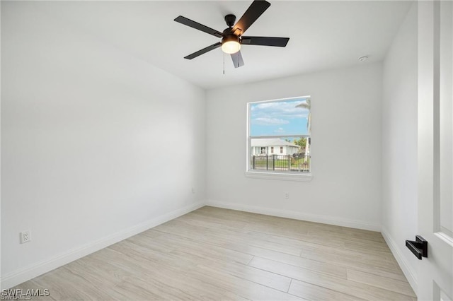 empty room with baseboards, ceiling fan, and light wood-style floors