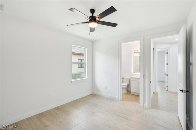 unfurnished bedroom with light wood-style floors, ceiling fan, ensuite bath, and baseboards