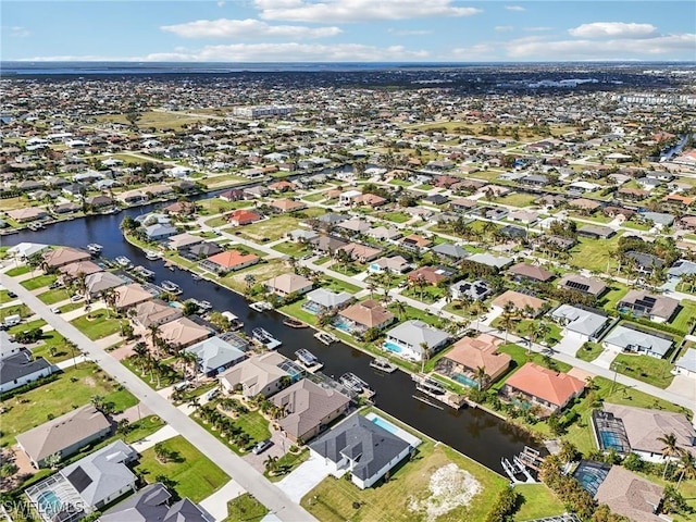 birds eye view of property featuring a residential view and a water view