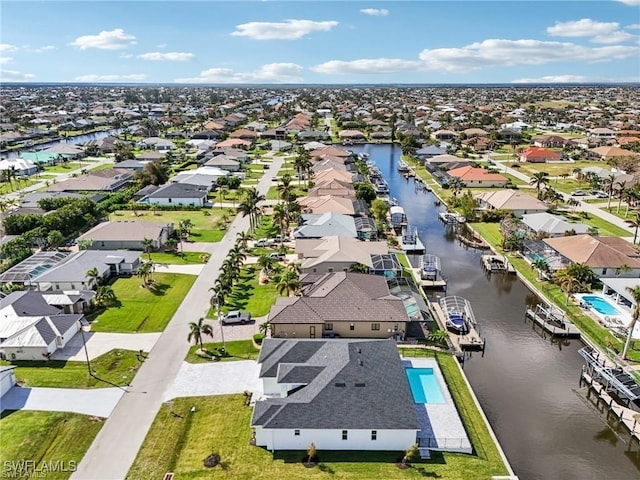 bird's eye view featuring a water view and a residential view