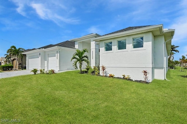 view of front of property with concrete driveway, a front yard, an attached garage, and stucco siding