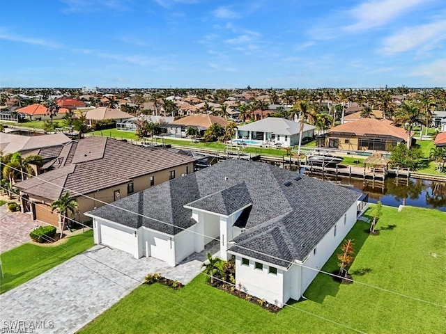 bird's eye view featuring a water view and a residential view