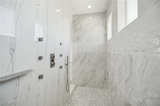 bathroom with a marble finish shower