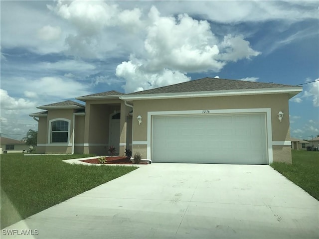 view of front of house with a garage and a front lawn