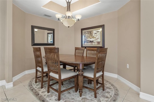 dining area with baseboards, visible vents, a chandelier, and light tile patterned flooring