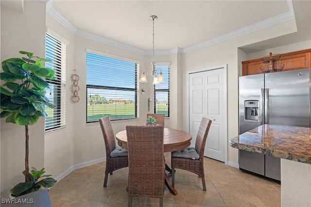 dining area featuring crown molding, baseboards, and light tile patterned floors