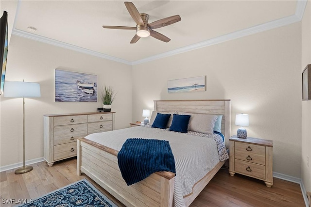 bedroom with ornamental molding, baseboards, and light wood finished floors