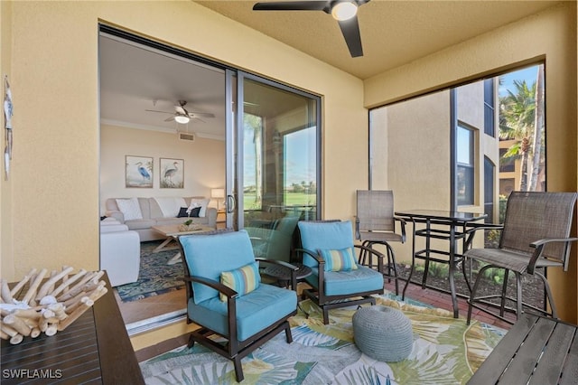 sunroom with ceiling fan and visible vents