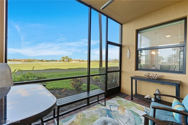 sunroom / solarium featuring view of golf course