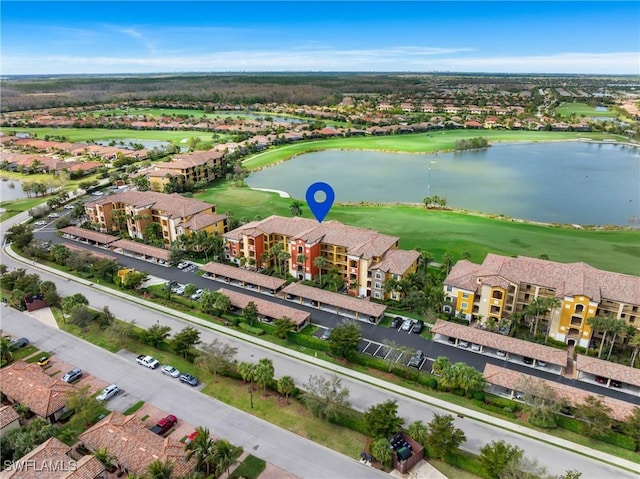 bird's eye view featuring view of golf course, a water view, and a residential view