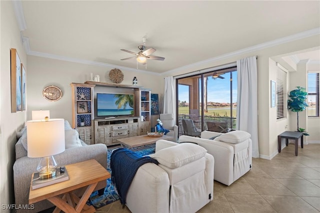 living room featuring light tile patterned floors, ceiling fan, baseboards, and crown molding