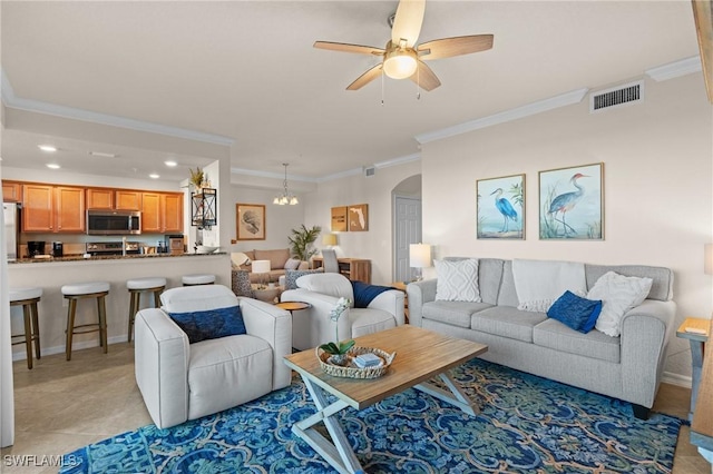 living area with arched walkways, recessed lighting, ceiling fan with notable chandelier, visible vents, and ornamental molding