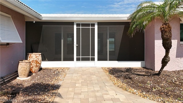 doorway to property with stucco siding