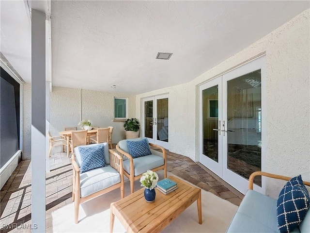 balcony featuring outdoor dining space, french doors, and a patio