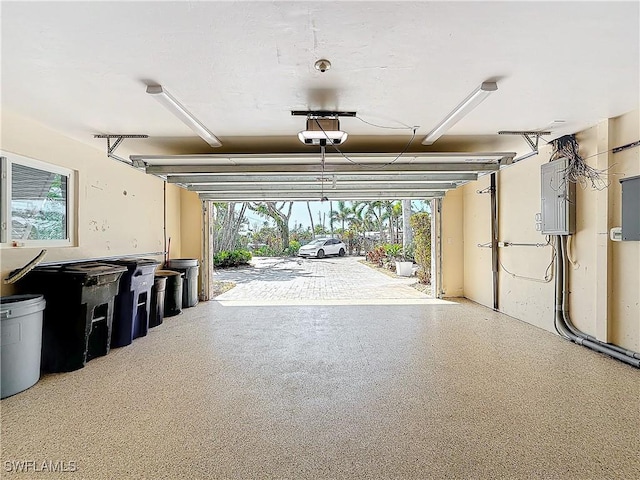 garage featuring a garage door opener and electric panel