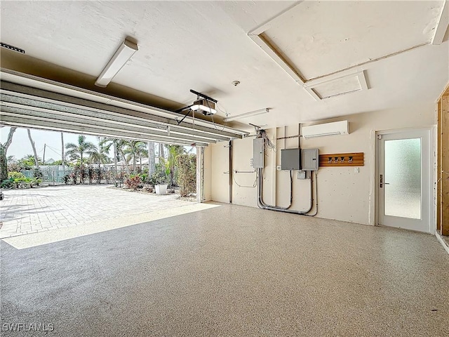 garage featuring an AC wall unit, electric panel, and a garage door opener