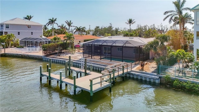 dock area featuring a water view, glass enclosure, boat lift, and fence