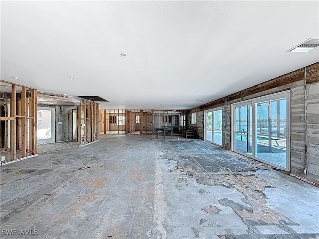 unfurnished living room with visible vents