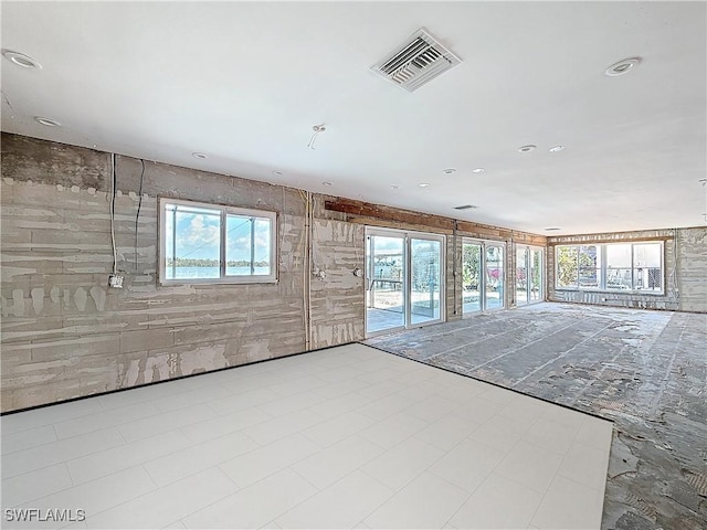 spare room with a wealth of natural light, tile patterned floors, visible vents, and recessed lighting