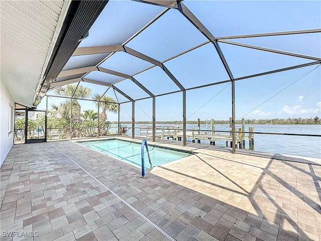 outdoor pool featuring glass enclosure, a boat dock, a patio area, and a water view