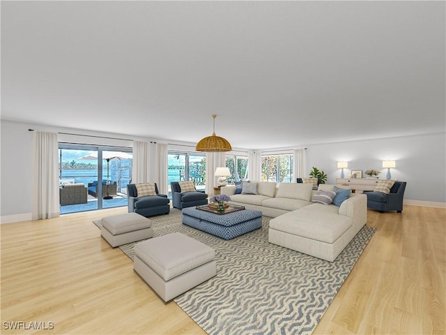 living room featuring light wood-style flooring and baseboards