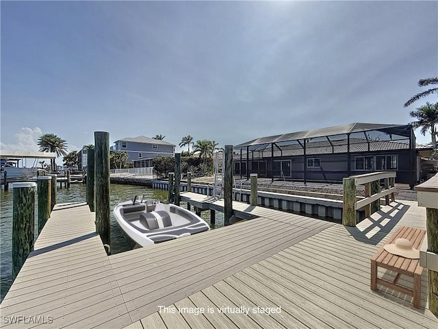 dock area with a water view and a lanai