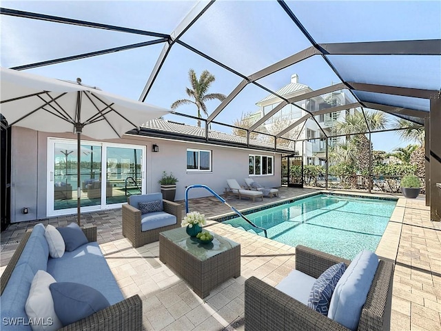 outdoor pool featuring an outdoor hangout area, glass enclosure, and a patio area