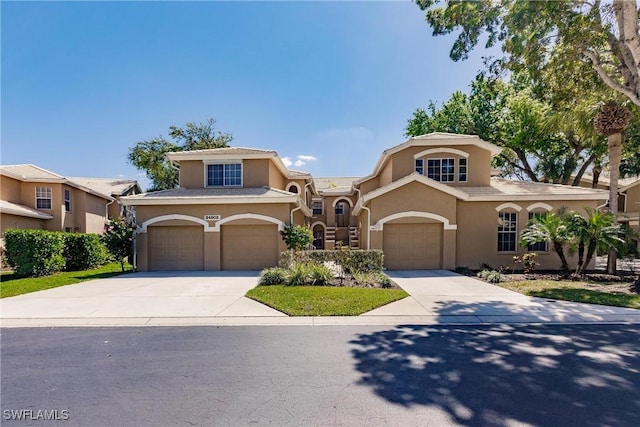 mediterranean / spanish-style home featuring stucco siding and driveway