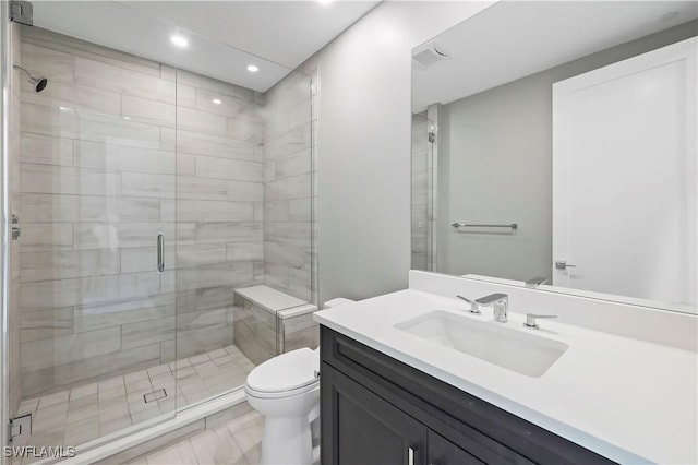 bathroom with vanity, an enclosed shower, and toilet