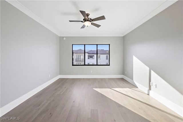 spare room featuring light hardwood / wood-style flooring, ceiling fan, and ornamental molding