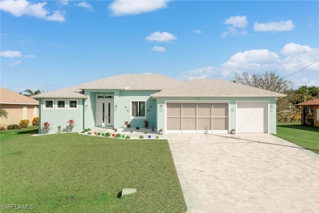 view of front of property with a front yard and a garage