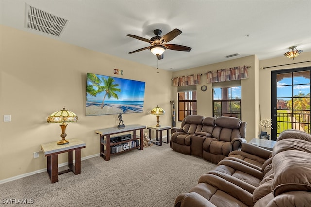 living room featuring carpet, visible vents, ceiling fan, and baseboards