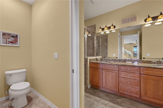 full bathroom with double vanity, baseboards, toilet, tile patterned flooring, and a shower stall