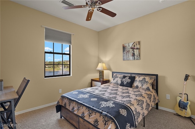 carpeted bedroom featuring a ceiling fan, visible vents, and baseboards