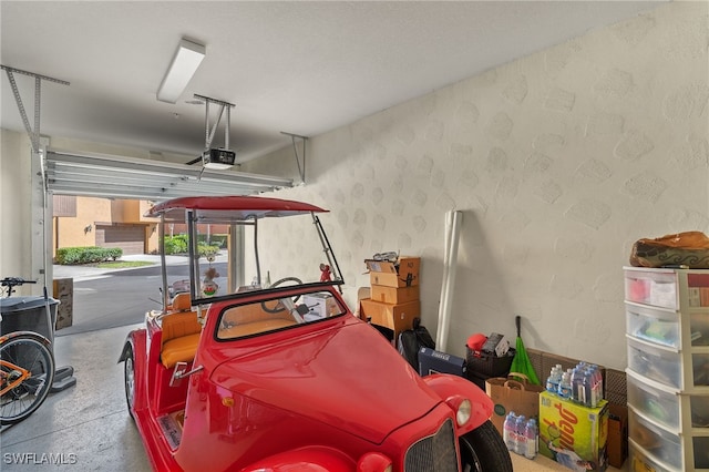 garage featuring a textured wall and a garage door opener