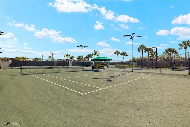 view of sport court featuring fence