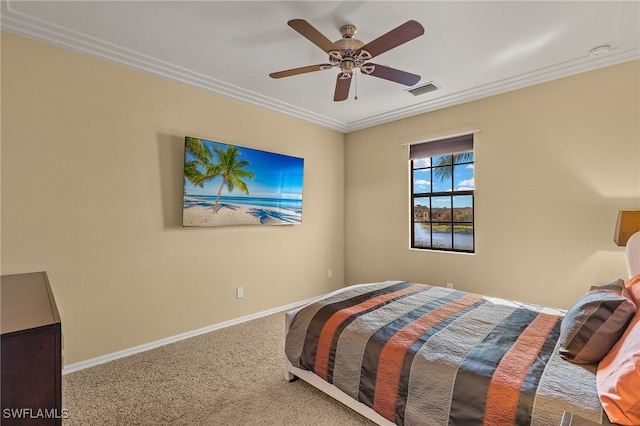 bedroom with visible vents, baseboards, a ceiling fan, carpet, and crown molding