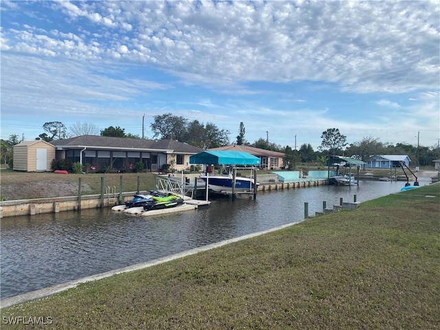 dock area featuring a water view and a yard