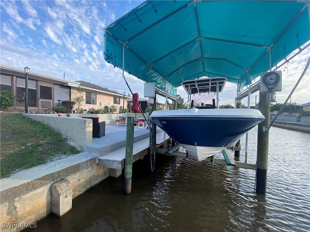 view of dock with a water view and boat lift