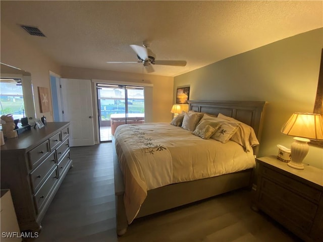 bedroom with visible vents, a ceiling fan, dark wood-style flooring, access to exterior, and a textured ceiling