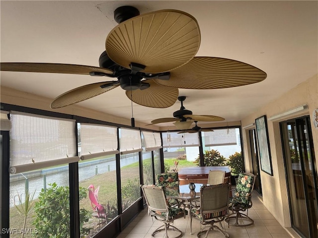 sunroom featuring ceiling fan