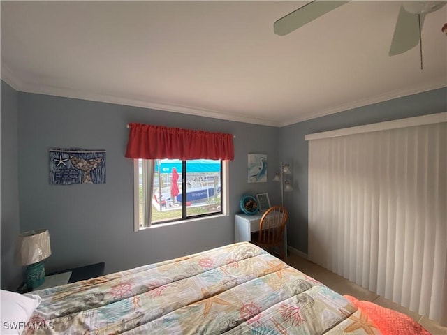 bedroom featuring ceiling fan, ornamental molding, and carpet flooring