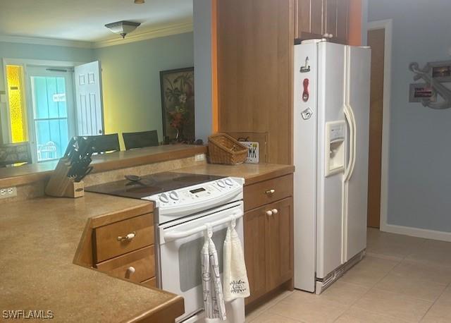 kitchen featuring brown cabinets, white appliances, light countertops, and crown molding
