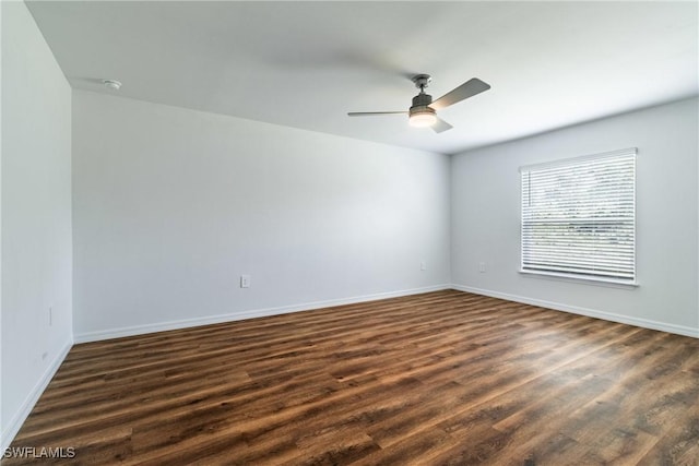 empty room with dark hardwood / wood-style flooring and ceiling fan