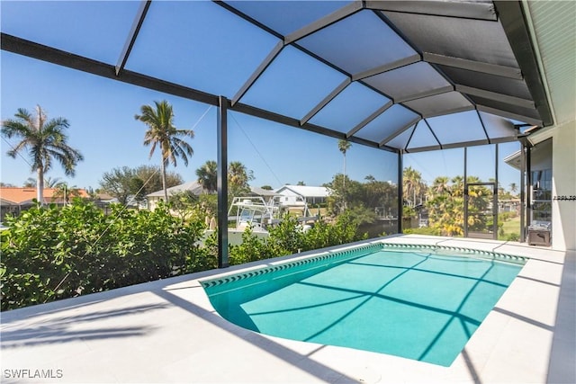 outdoor pool featuring a patio area, a residential view, and a lanai